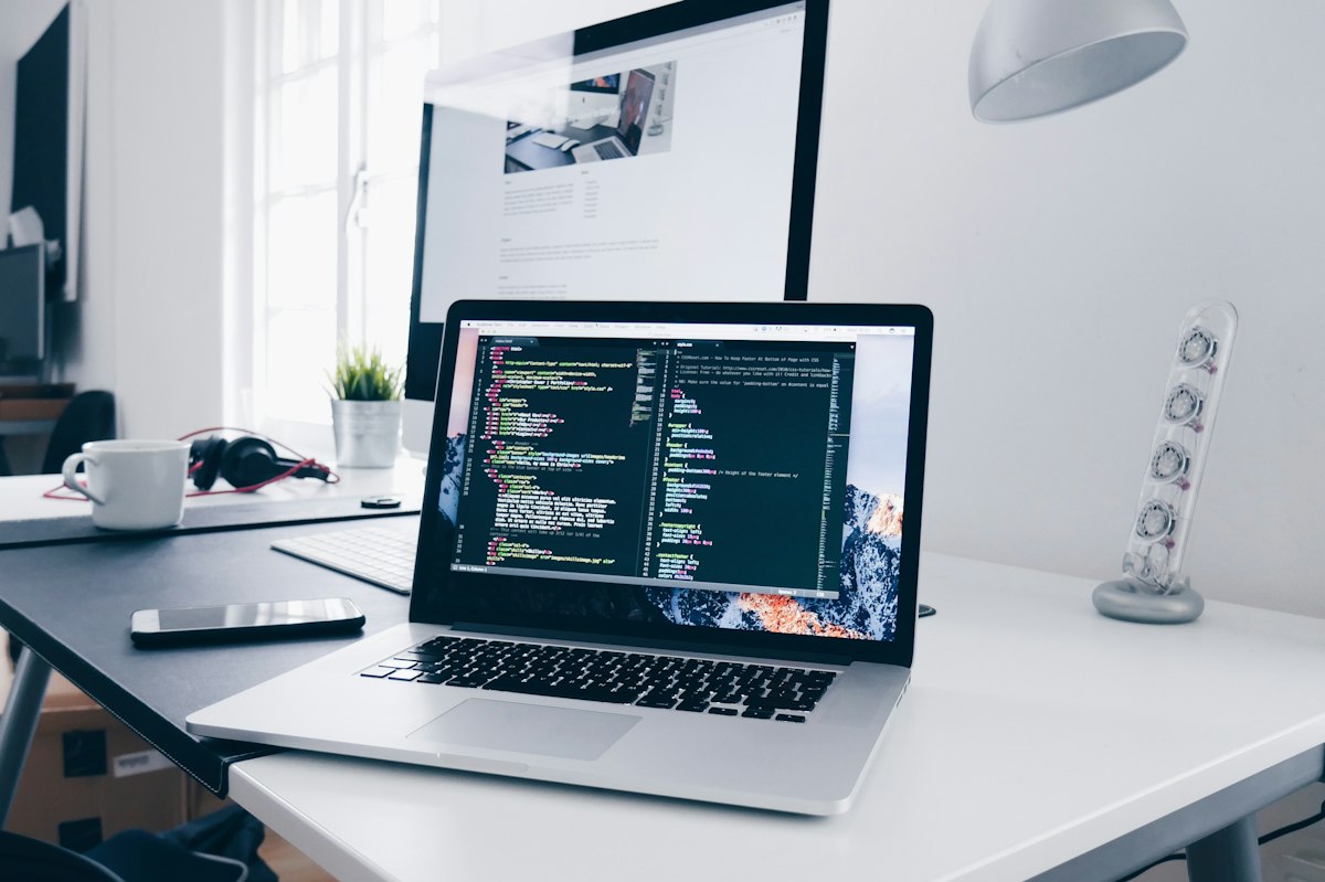 Clean modern laptop running HTML and CSS code in a developer workspace